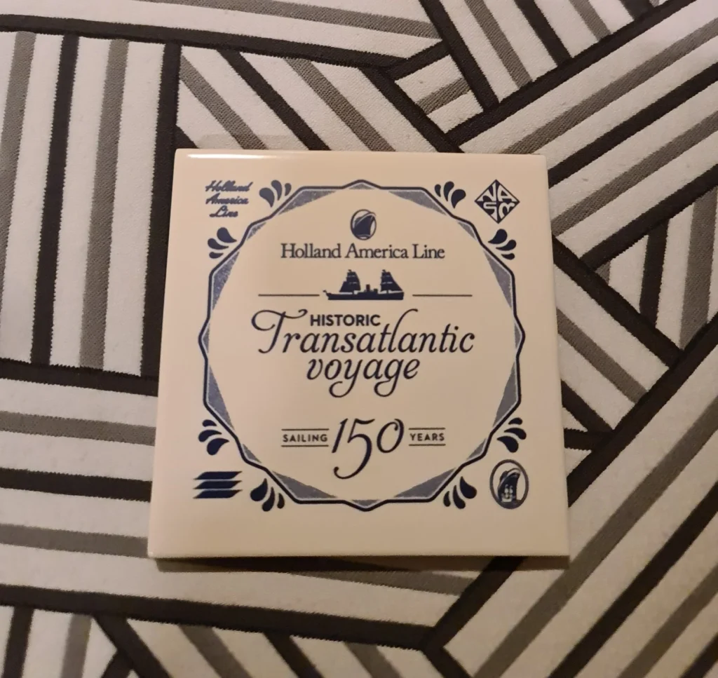 Cruising with Danny and Peter, Holland America Line, Rotterdam, Rotterdam, The Netherlands | A stunning view of the M.S. Rotterdam as it sails away from Rotterdam, celebrating Holland America 150th Anniversary with historic ships in the background. The sunset casts a golden glow on the luxury ocean liner, capturing the excitement of our transatlantic voyage from Rotterdam to New York. A special anniversary menu and Holland America memorabilia highlight this remarkable journey.