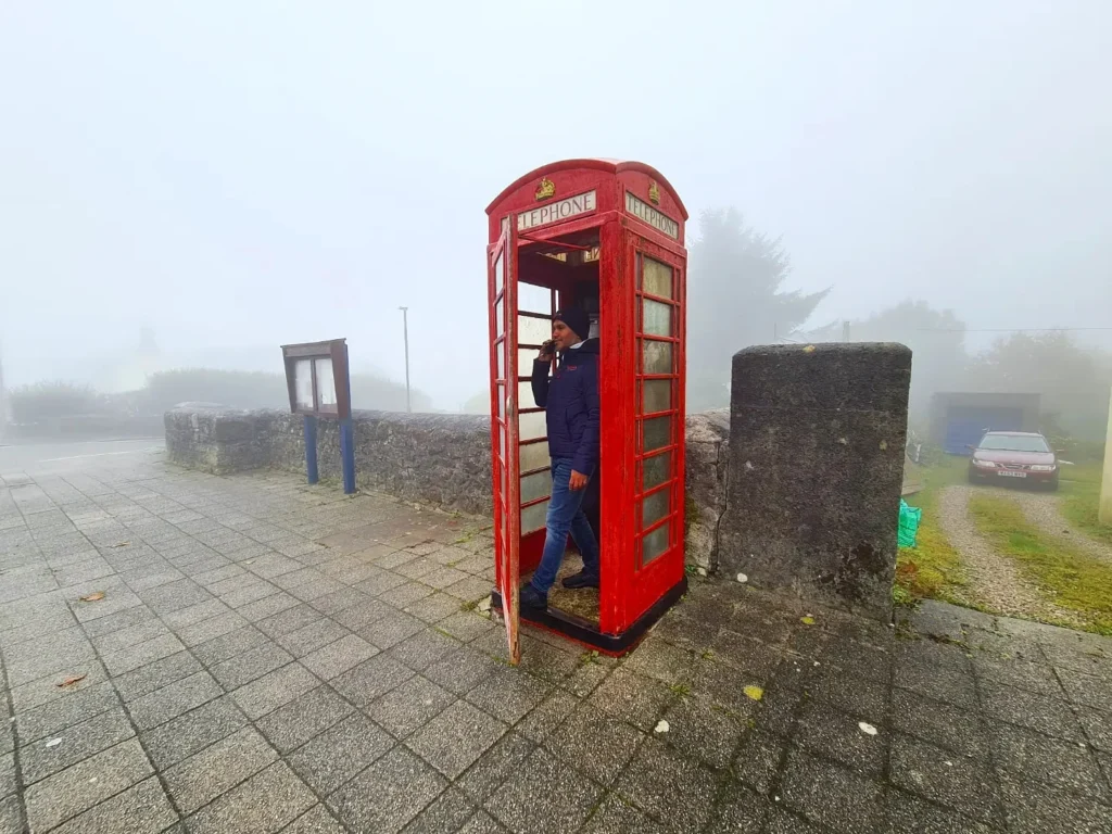 Cruising with Danny and Peter, Holland America Line, Rotterdam, Plymouth, England, Great Britain, United Kingdom | A foggy day in Plymouth Dartmoor showcases an eerie scene of historic churches and spooky graveyards, highlighting the enchanting beauty of Plymouth UK travel. A winding hiking trail through Dartmoor National Park is visible, surrounded by lush greenery and misty landscapes.