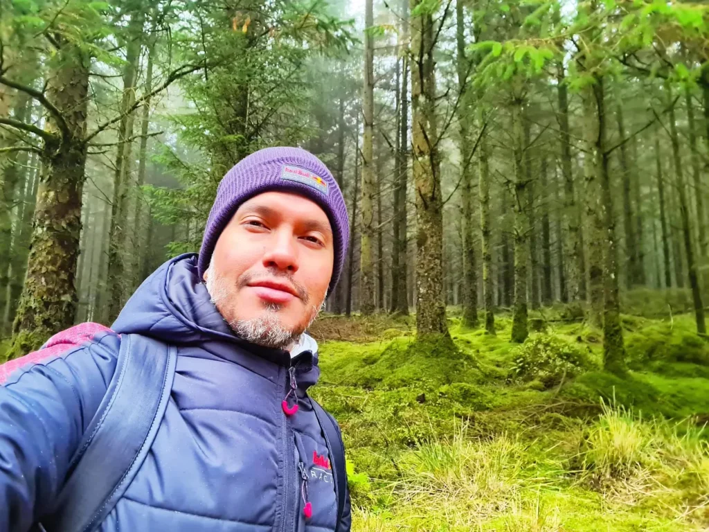 Cruising with Danny and Peter, Holland America Line, Rotterdam, Plymouth, England, Great Britain, United Kingdom | A foggy day in Plymouth Dartmoor showcases an eerie scene of historic churches and spooky graveyards, highlighting the enchanting beauty of Plymouth UK travel. A winding hiking trail through Dartmoor National Park is visible, surrounded by lush greenery and misty landscapes.