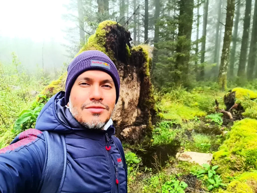 Cruising with Danny and Peter, Holland America Line, Rotterdam, Plymouth, England, Great Britain, United Kingdom | A foggy day in Plymouth Dartmoor showcases an eerie scene of historic churches and spooky graveyards, highlighting the enchanting beauty of Plymouth UK travel. A winding hiking trail through Dartmoor National Park is visible, surrounded by lush greenery and misty landscapes.