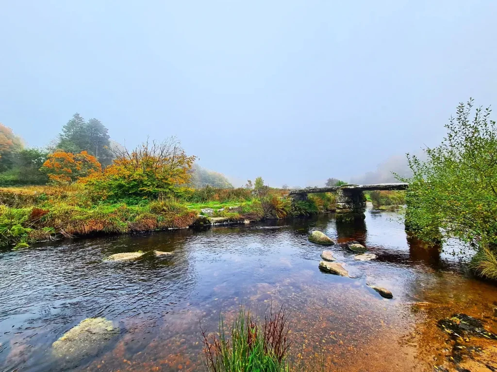 Cruising with Danny and Peter, Holland America Line, Rotterdam, Plymouth, England, Great Britain, United Kingdom | A foggy day in Plymouth Dartmoor showcases an eerie scene of historic churches and spooky graveyards, highlighting the enchanting beauty of Plymouth UK travel. A winding hiking trail through Dartmoor National Park is visible, surrounded by lush greenery and misty landscapes.