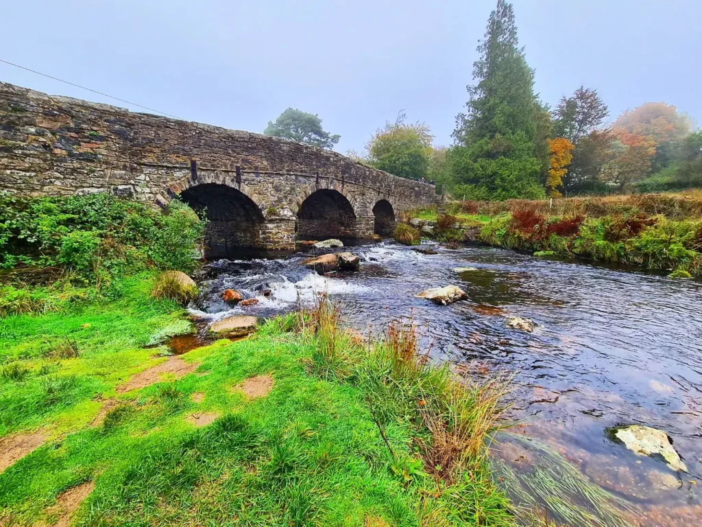 Cruising with Danny and Peter, Holland America Line, Rotterdam, Plymouth, England, Great Britain, United Kingdom | A foggy day in Plymouth Dartmoor showcases an eerie scene of historic churches and spooky graveyards, highlighting the enchanting beauty of Plymouth UK travel. A winding hiking trail through Dartmoor National Park is visible, surrounded by lush greenery and misty landscapes.