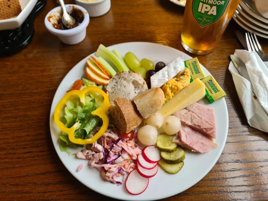 Cruising with Danny and Peter, Holland America Line, Rotterdam, Plymouth, England, Great Britain, United Kingdom | A foggy day in Plymouth Dartmoor showcases an eerie scene of historic churches and spooky graveyards, highlighting the enchanting beauty of Plymouth UK travel. A winding hiking trail through Dartmoor National Park is visible, surrounded by lush greenery and misty landscapes.