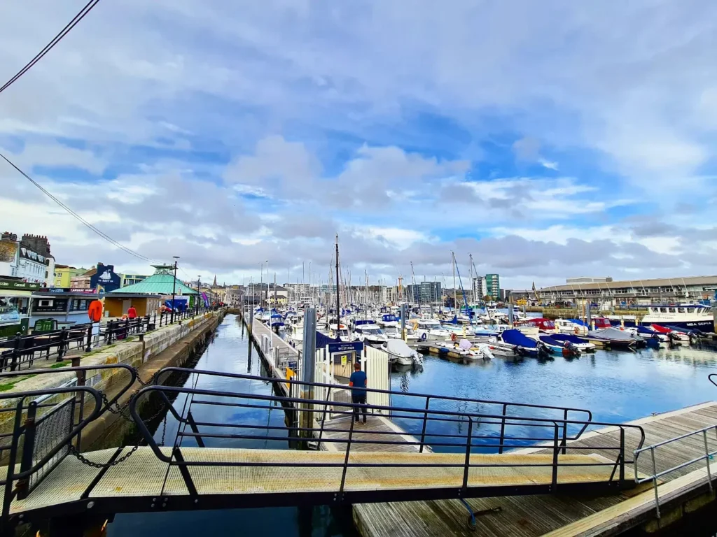 Cruising with Danny and Peter, Holland America Line, Rotterdam, Plymouth, England, Great Britain, United Kingdom | A foggy day in Plymouth Dartmoor showcases an eerie scene of historic churches and spooky graveyards, highlighting the enchanting beauty of Plymouth UK travel. A winding hiking trail through Dartmoor National Park is visible, surrounded by lush greenery and misty landscapes.