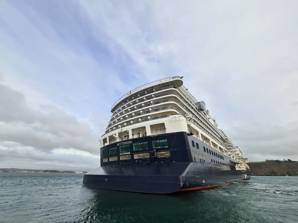 Cruising with Danny and Peter, Holland America Line, Rotterdam, Plymouth, England, Great Britain, United Kingdom | A foggy day in Plymouth Dartmoor showcases an eerie scene of historic churches and spooky graveyards, highlighting the enchanting beauty of Plymouth UK travel. A winding hiking trail through Dartmoor National Park is visible, surrounded by lush greenery and misty landscapes.
