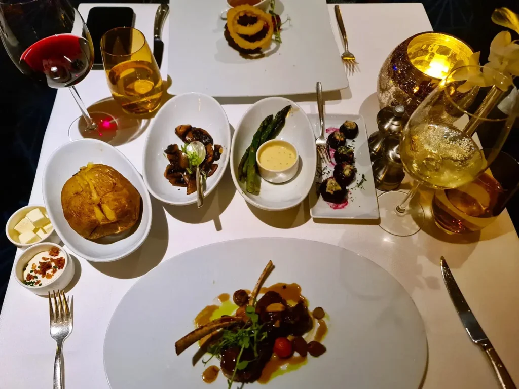 Cruising with Danny and Peter, Holland America Line, Rotterdam, Atlantic Ocean, Sea Day | Guests enjoying the first sea day on the Holland America Line 150th Anniversary Cruise aboard the Rotterdam, featuring scenic Atlantic Ocean views, elegant dining at the Pinnacle Grill, onboard events like the Mariners Society meeting on the Lido Deck, and morning breakfast selections. A memorable day at sea during Holland America Line’s milestone voyage celebration.