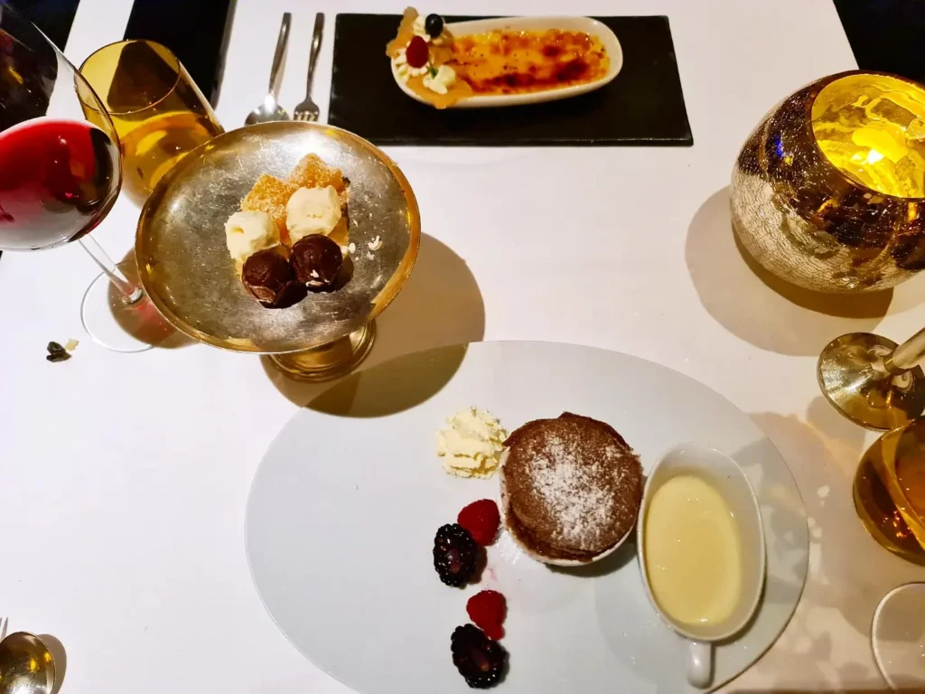 Cruising with Danny and Peter, Holland America Line, Rotterdam, Atlantic Ocean, Sea Day | Guests enjoying the first sea day on the Holland America Line 150th Anniversary Cruise aboard the Rotterdam, featuring scenic Atlantic Ocean views, elegant dining at the Pinnacle Grill, onboard events like the Mariners Society meeting on the Lido Deck, and morning breakfast selections. A memorable day at sea during Holland America Line’s milestone voyage celebration.