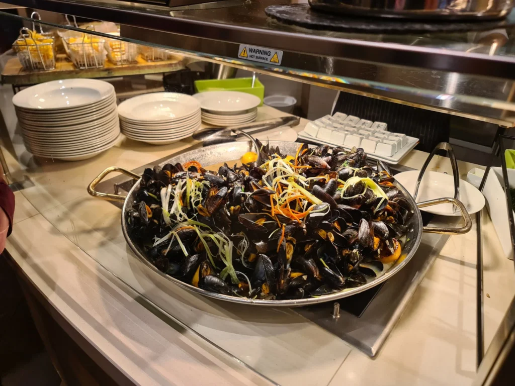 Cruising with Danny and Peter, Holland America Line, Rotterdam, Atlantic Ocean, Sea Day | Guests enjoying the first sea day on the Holland America Line 150th Anniversary Cruise aboard the Rotterdam, featuring scenic Atlantic Ocean views, elegant dining at the Pinnacle Grill, onboard events like the Mariners Society meeting on the Lido Deck, and morning breakfast selections. A memorable day at sea during Holland America Line’s milestone voyage celebration.