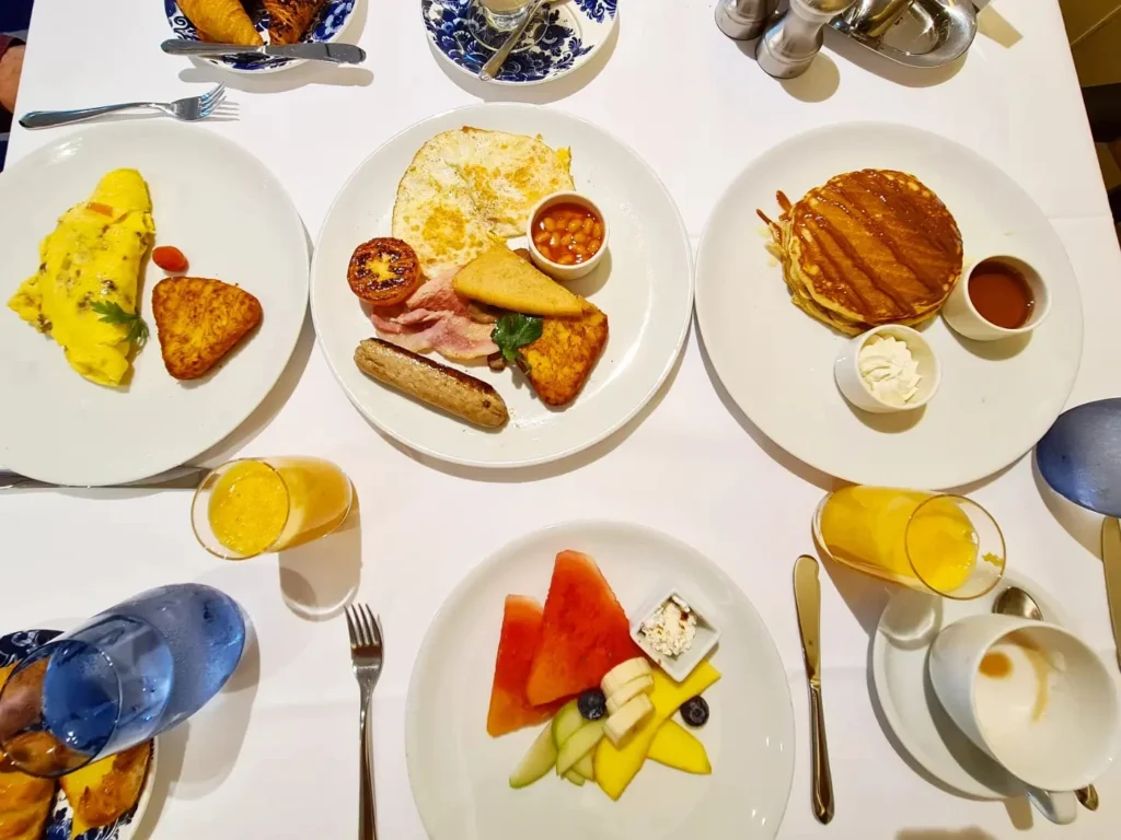 Cruising with Danny and Peter, Holland America Line, Rotterdam, Atlantic Ocean, Sea Day | Guests enjoying the first sea day on the Holland America Line 150th Anniversary Cruise aboard the Rotterdam, featuring scenic Atlantic Ocean views, elegant dining at the Pinnacle Grill, onboard events like the Mariners Society meeting on the Lido Deck, and morning breakfast selections. A memorable day at sea during Holland America Line’s milestone voyage celebration.