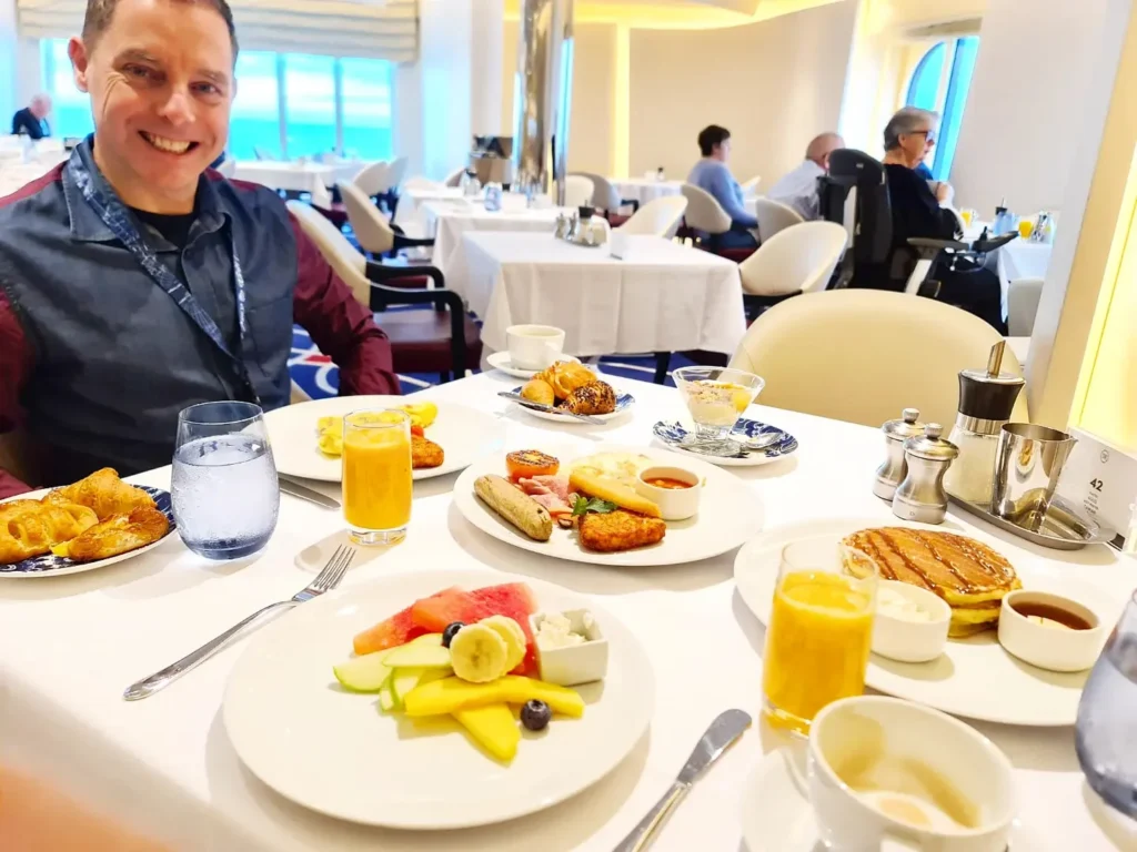 Cruising with Danny and Peter, Holland America Line, Rotterdam, Atlantic Ocean, Sea Day | Guests enjoying the first sea day on the Holland America Line 150th Anniversary Cruise aboard the Rotterdam, featuring scenic Atlantic Ocean views, elegant dining at the Pinnacle Grill, onboard events like the Mariners Society meeting on the Lido Deck, and morning breakfast selections. A memorable day at sea during Holland America Line’s milestone voyage celebration.