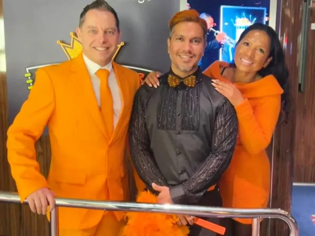 Cruising with Danny and Peter, Holland America Line, Rotterdam, Atlantic Ocean, Sea Day | Guests celebrating the Orange Party Holland America 150th Anniversary aboard the MS Rotterdam, enjoying live music, Dutch treats like Kapsalon, Poffertjes, and Kleine Appeltaart, while wearing orange attire in honor of Dutch heritage and the Holland America anniversary party.