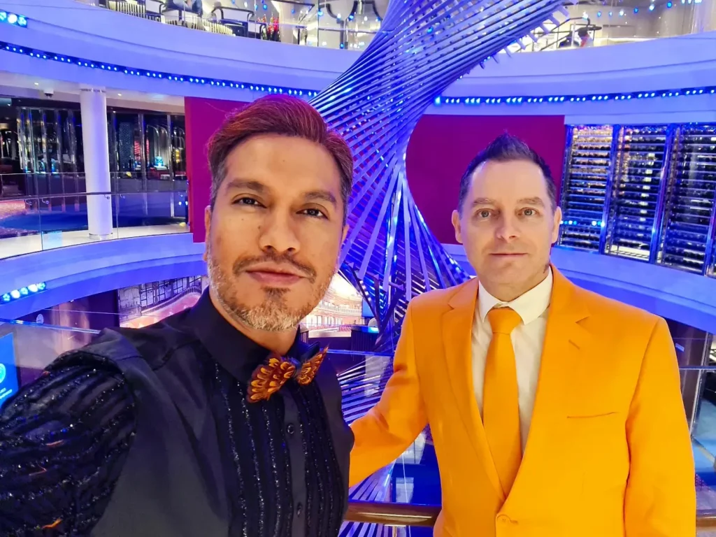 Cruising with Danny and Peter, Holland America Line, Rotterdam, Atlantic Ocean, Sea Day | Guests celebrating the Orange Party Holland America 150th Anniversary aboard the MS Rotterdam, enjoying live music, Dutch treats like Kapsalon, Poffertjes, and Kleine Appeltaart, while wearing orange attire in honor of Dutch heritage and the Holland America anniversary party.