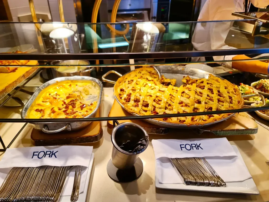 Cruising with Danny and Peter, Holland America Line, Rotterdam, Atlantic Ocean, Sea Day | Guests celebrating the Orange Party Holland America 150th Anniversary aboard the MS Rotterdam, enjoying live music, Dutch treats like Kapsalon, Poffertjes, and Kleine Appeltaart, while wearing orange attire in honor of Dutch heritage and the Holland America anniversary party.