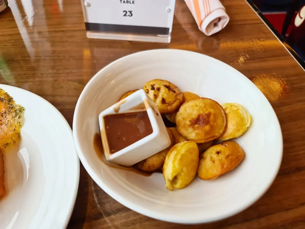 Cruising with Danny and Peter, Holland America Line, Rotterdam, Atlantic Ocean, Sea Day | Guests celebrating the Orange Party Holland America 150th Anniversary aboard the MS Rotterdam, enjoying live music, Dutch treats like Kapsalon, Poffertjes, and Kleine Appeltaart, while wearing orange attire in honor of Dutch heritage and the Holland America anniversary party.