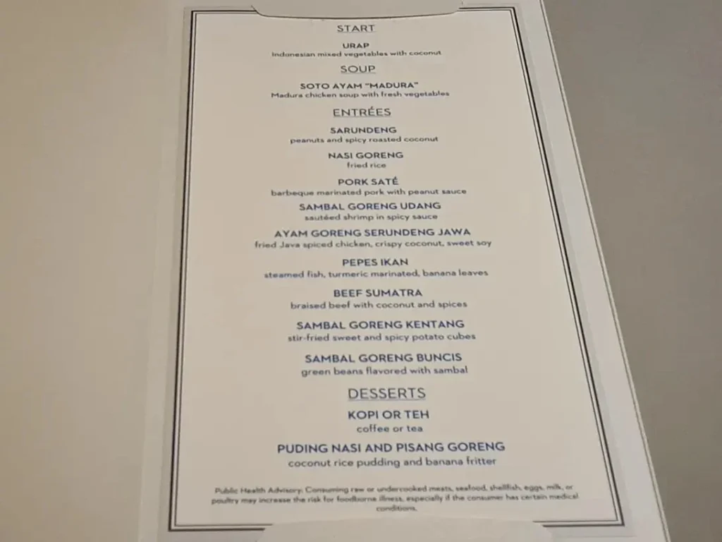 Cruising with Danny and Peter, Holland America Line, Rotterdam, Atlantic Ocean, Sea Day | Indonesian Rijsttafel at Sea served at the Tamarind restaurant aboard the Rotterdam cruise, showcasing vibrant dishes including Soto Ayam Madura, Nasi Goreng, and Pork Sate, alongside a Wasabi martini and Jalapeño martini, highlighting the unique culinary experience and ambiance of specialty restaurants on the cruise.