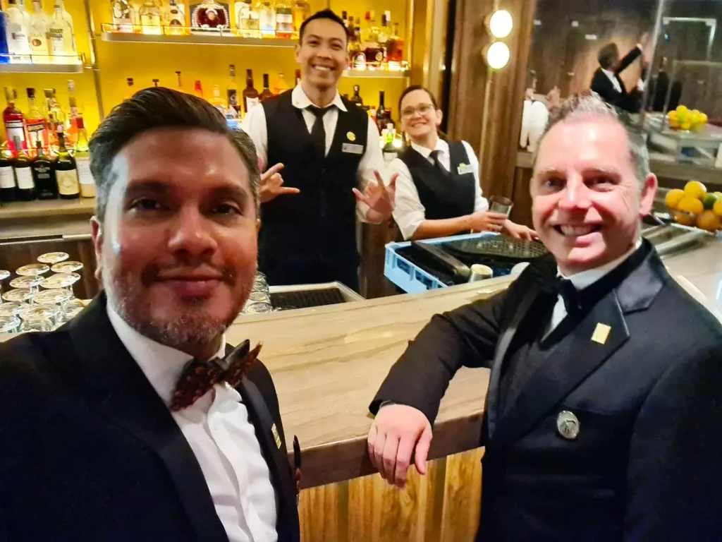 Cruising with Danny and Peter, Holland America Line, Rotterdam, Atlantic Ocean, Sea Day | Indonesian Rijsttafel at Sea served at the Tamarind restaurant aboard the Rotterdam cruise, showcasing vibrant dishes including Soto Ayam Madura, Nasi Goreng, and Pork Sate, alongside a Wasabi martini and Jalapeño martini, highlighting the unique culinary experience and ambiance of specialty restaurants on the cruise.
