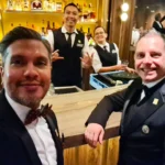 Cruising with Danny and Peter, Holland America Line, Rotterdam, Atlantic Ocean, Sea Day | Indonesian Rijsttafel at Sea served at the Tamarind restaurant aboard the Rotterdam cruise, showcasing vibrant dishes including Soto Ayam Madura, Nasi Goreng, and Pork Sate, alongside a Wasabi martini and Jalapeño martini, highlighting the unique culinary experience and ambiance of specialty restaurants on the cruise.