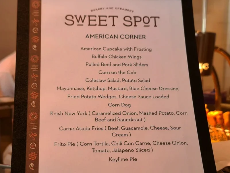 Cruising with Danny and Peter, Holland America Line, Rotterdam, Atlantic Ocean, Sea Day | Indonesian Rijsttafel at Sea served at the Tamarind restaurant aboard the Rotterdam cruise, showcasing vibrant dishes including Soto Ayam Madura, Nasi Goreng, and Pork Sate, alongside a Wasabi martini and Jalapeño martini, highlighting the unique culinary experience and ambiance of specialty restaurants on the cruise.