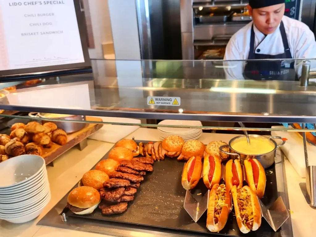 Cruising with Danny and Peter, Holland America Line, Rotterdam, Atlantic Ocean, Sea Day | Indonesian Rijsttafel at Sea served at the Tamarind restaurant aboard the Rotterdam cruise, showcasing vibrant dishes including Soto Ayam Madura, Nasi Goreng, and Pork Sate, alongside a Wasabi martini and Jalapeño martini, highlighting the unique culinary experience and ambiance of specialty restaurants on the cruise.