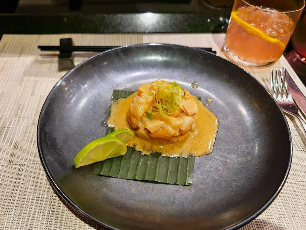 Cruising with Danny and Peter, Holland America Line, Rotterdam, Atlantic Ocean, Sea Day | A luxurious Sushi night MS Rotterdam experience aboard Holland America Line, featuring a variety of fresh sushi dishes like Hamachi, scallop ceviche, seared albacore tuna, and fried soft shell crab sushi, accompanied by cocktails at the Oceanview sushi restaurant with stunning ocean views, showcasing the Best sushi at sea during a memorable Sushi dining aboard MS Rotterdam.