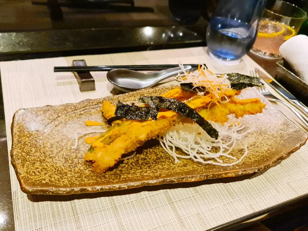 Cruising with Danny and Peter, Holland America Line, Rotterdam, Atlantic Ocean, Sea Day | A luxurious Sushi night MS Rotterdam experience aboard Holland America Line, featuring a variety of fresh sushi dishes like Hamachi, scallop ceviche, seared albacore tuna, and fried soft shell crab sushi, accompanied by cocktails at the Oceanview sushi restaurant with stunning ocean views, showcasing the Best sushi at sea during a memorable Sushi dining aboard MS Rotterdam.