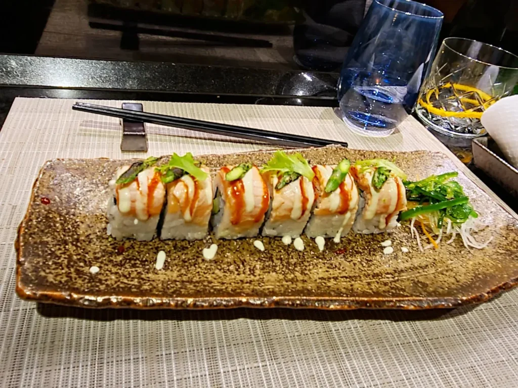 Cruising with Danny and Peter, Holland America Line, Rotterdam, Atlantic Ocean, Sea Day | A luxurious Sushi night MS Rotterdam experience aboard Holland America Line, featuring a variety of fresh sushi dishes like Hamachi, scallop ceviche, seared albacore tuna, and fried soft shell crab sushi, accompanied by cocktails at the Oceanview sushi restaurant with stunning ocean views, showcasing the Best sushi at sea during a memorable Sushi dining aboard MS Rotterdam.