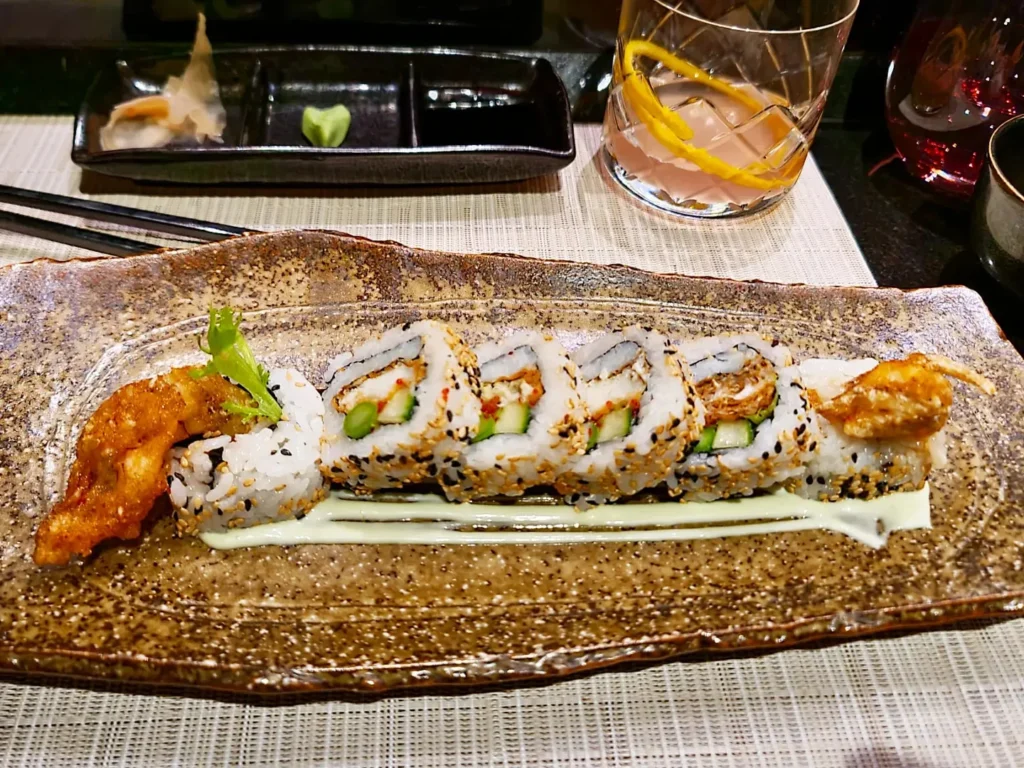 Cruising with Danny and Peter, Holland America Line, Rotterdam, Atlantic Ocean, Sea Day | A luxurious Sushi night MS Rotterdam experience aboard Holland America Line, featuring a variety of fresh sushi dishes like Hamachi, scallop ceviche, seared albacore tuna, and fried soft shell crab sushi, accompanied by cocktails at the Oceanview sushi restaurant with stunning ocean views, showcasing the Best sushi at sea during a memorable Sushi dining aboard MS Rotterdam.