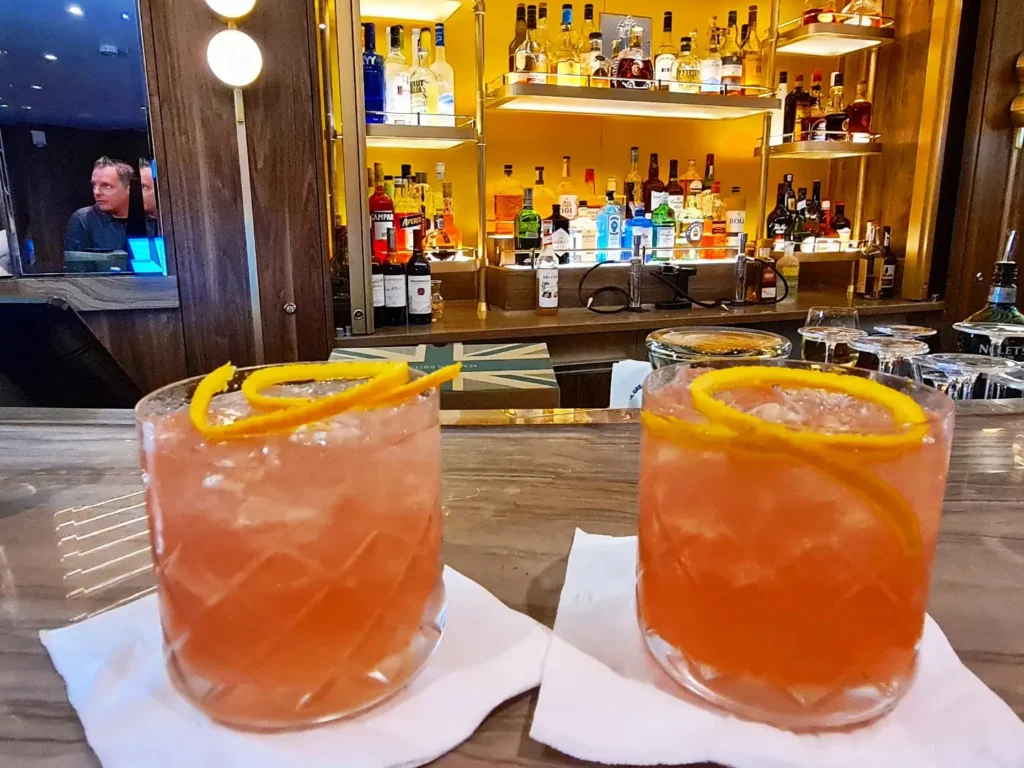 Cruising with Danny and Peter, Holland America Line, Rotterdam, Atlantic Ocean, Sea Day | A luxurious Sushi night MS Rotterdam experience aboard Holland America Line, featuring a variety of fresh sushi dishes like Hamachi, scallop ceviche, seared albacore tuna, and fried soft shell crab sushi, accompanied by cocktails at the Oceanview sushi restaurant with stunning ocean views, showcasing the Best sushi at sea during a memorable Sushi dining aboard MS Rotterdam.