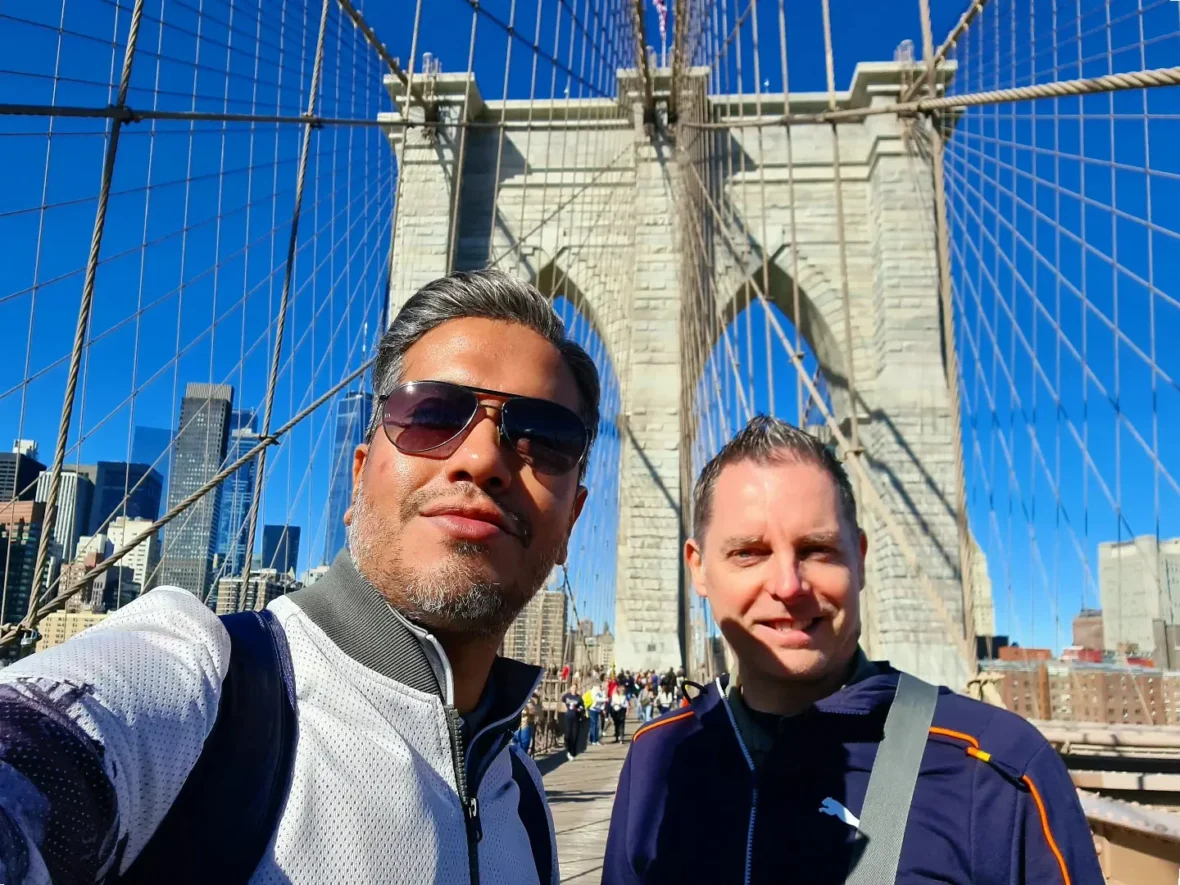 Cruising with Danny and Peter, Holland America Line, Rotterdam, New York, United States | Stunning views of the Brooklyn Bridge and Manhattan skyline during a New York City adventure, exploring iconic NYC bridges and 9/11 Memorial with panoramic views from the One World Observatory, capturing the vibrant energy of Times Square attractions and the historic NYC Financial District tour.