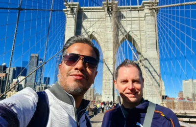 Cruising with Danny and Peter, Holland America Line, Rotterdam, New York, United States | Stunning views of the Brooklyn Bridge and Manhattan skyline during a New York City adventure, exploring iconic NYC bridges and 9/11 Memorial with panoramic views from the One World Observatory, capturing the vibrant energy of Times Square attractions and the historic NYC Financial District tour.