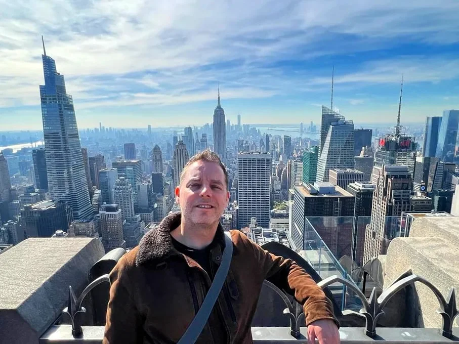 Cruising with Danny and Peter, Holland America Line, Rotterdam, New York, United States | View of iconic New York City landmarks including the Top of the Rock, Saint Patrick's Cathedral, MoMA, and the Flatiron Building, showcasing famous NYC art museums and historic monuments.