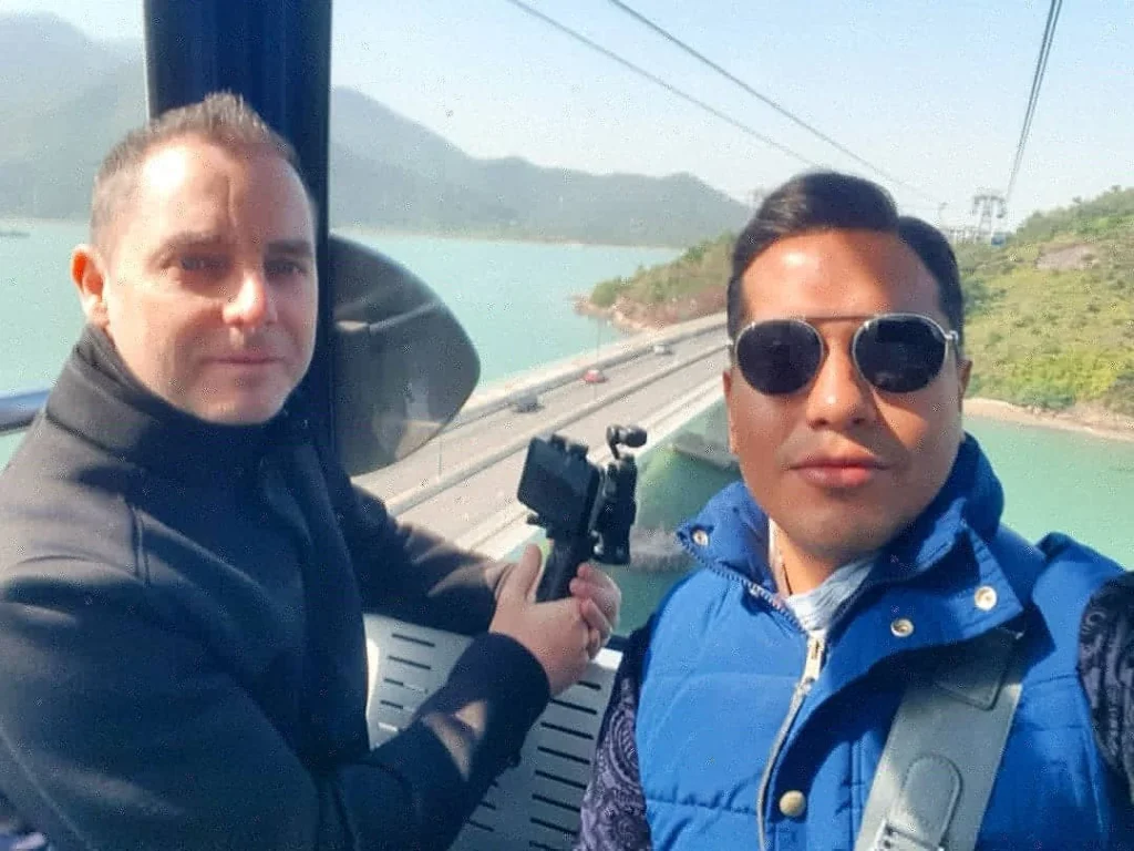 Cruising with Danny and Peter, Holland America Line, Westerdam, Hong Kong, China | A breathtaking view from Ngong Ping 360 cable car showcasing lush landscapes and the South China Sea, capturing the serene beauty of Lantau Island. A majestic shot of the Tian Tan Buddha, surrounded by the tranquil Po Lin Monastery, illustrating the cultural richness of Hong Kong. The vibrant skyline of Hong Kong from Victoria Peak, highlighting the dynamic cityscape during sunset, with twinkling lights illuminating the urban landscape, representing the perfect blend of nature and urbanity in these unforgettable Hong Kong Adventures.