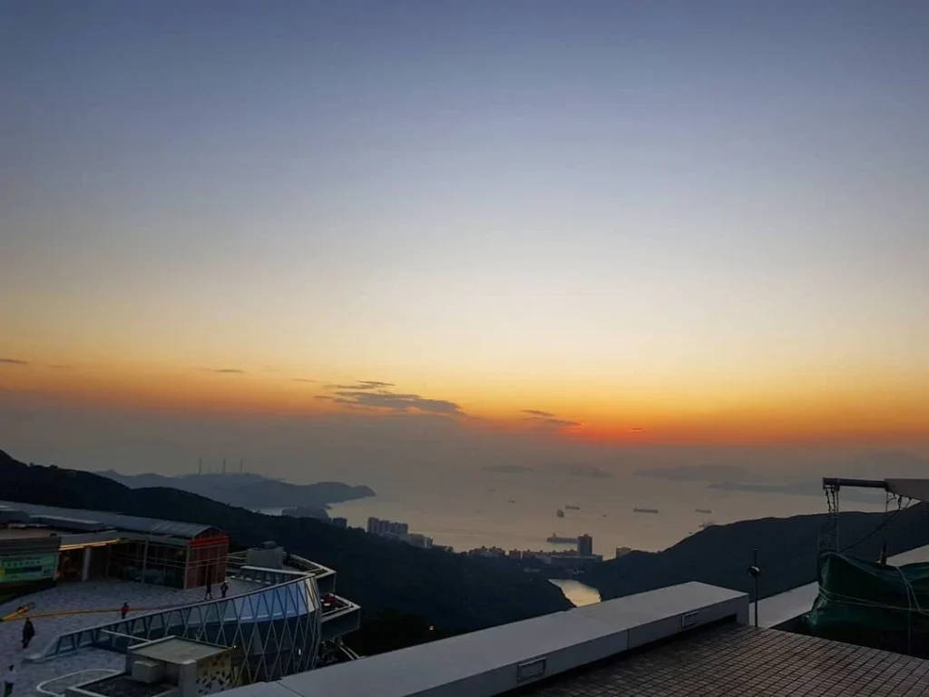 Cruising with Danny and Peter, Holland America Line, Westerdam, Hong Kong, China | A breathtaking view from Ngong Ping 360 cable car showcasing lush landscapes and the South China Sea, capturing the serene beauty of Lantau Island. A majestic shot of the Tian Tan Buddha, surrounded by the tranquil Po Lin Monastery, illustrating the cultural richness of Hong Kong. The vibrant skyline of Hong Kong from Victoria Peak, highlighting the dynamic cityscape during sunset, with twinkling lights illuminating the urban landscape, representing the perfect blend of nature and urbanity in these unforgettable Hong Kong Adventures.
