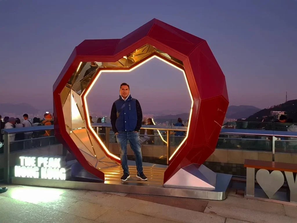 Cruising with Danny and Peter, Holland America Line, Westerdam, Hong Kong, China | A breathtaking view from Ngong Ping 360 cable car showcasing lush landscapes and the South China Sea, capturing the serene beauty of Lantau Island. A majestic shot of the Tian Tan Buddha, surrounded by the tranquil Po Lin Monastery, illustrating the cultural richness of Hong Kong. The vibrant skyline of Hong Kong from Victoria Peak, highlighting the dynamic cityscape during sunset, with twinkling lights illuminating the urban landscape, representing the perfect blend of nature and urbanity in these unforgettable Hong Kong Adventures.