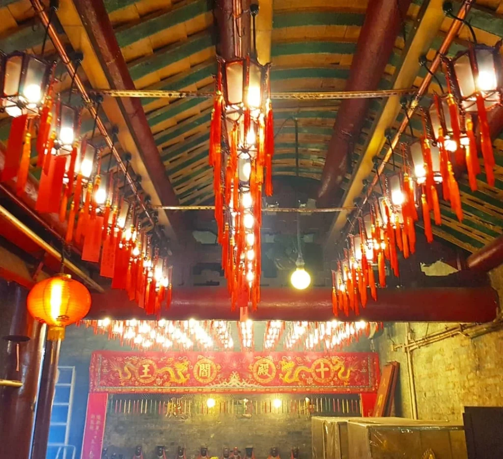 Cruising with Danny and Peter, Holland America Line, Westerdam, Hong Kong, China | A vibrant scene of Hong Kong's skyline during sunset, showcasing the majestic Westerdam cruise ship docked at the harbor, with tourists exploring the iconic Man Mo Temple, highlighting the cultural richness and luxury of a Hong Kong cruise experience.