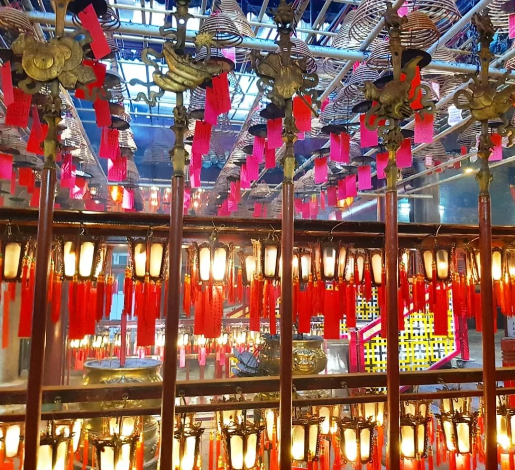 Cruising with Danny and Peter, Holland America Line, Westerdam, Hong Kong, China | A vibrant scene of Hong Kong's skyline during sunset, showcasing the majestic Westerdam cruise ship docked at the harbor, with tourists exploring the iconic Man Mo Temple, highlighting the cultural richness and luxury of a Hong Kong cruise experience.