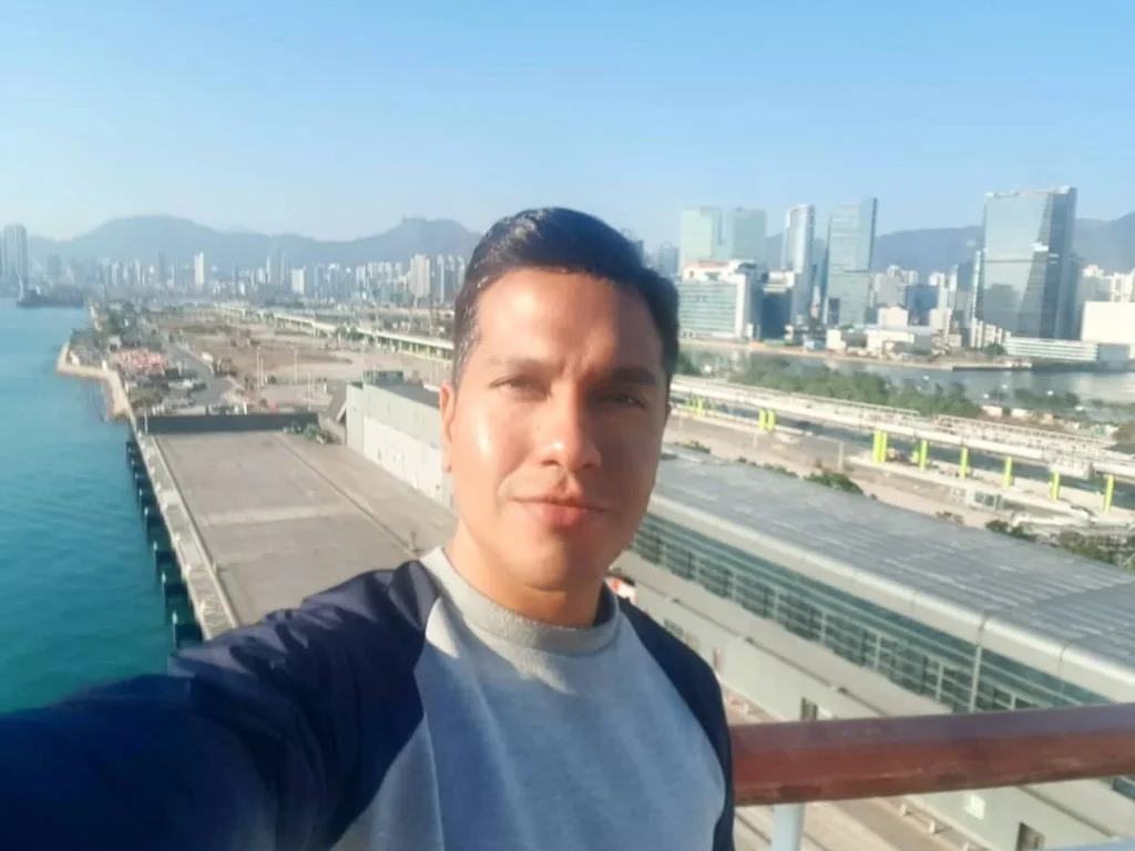 Cruising with Danny and Peter, Holland America Line, Westerdam, Hong Kong, China | A vibrant scene of Hong Kong's skyline during sunset, showcasing the majestic Westerdam cruise ship docked at the harbor, with tourists exploring the iconic Man Mo Temple, highlighting the cultural richness and luxury of a Hong Kong cruise experience.