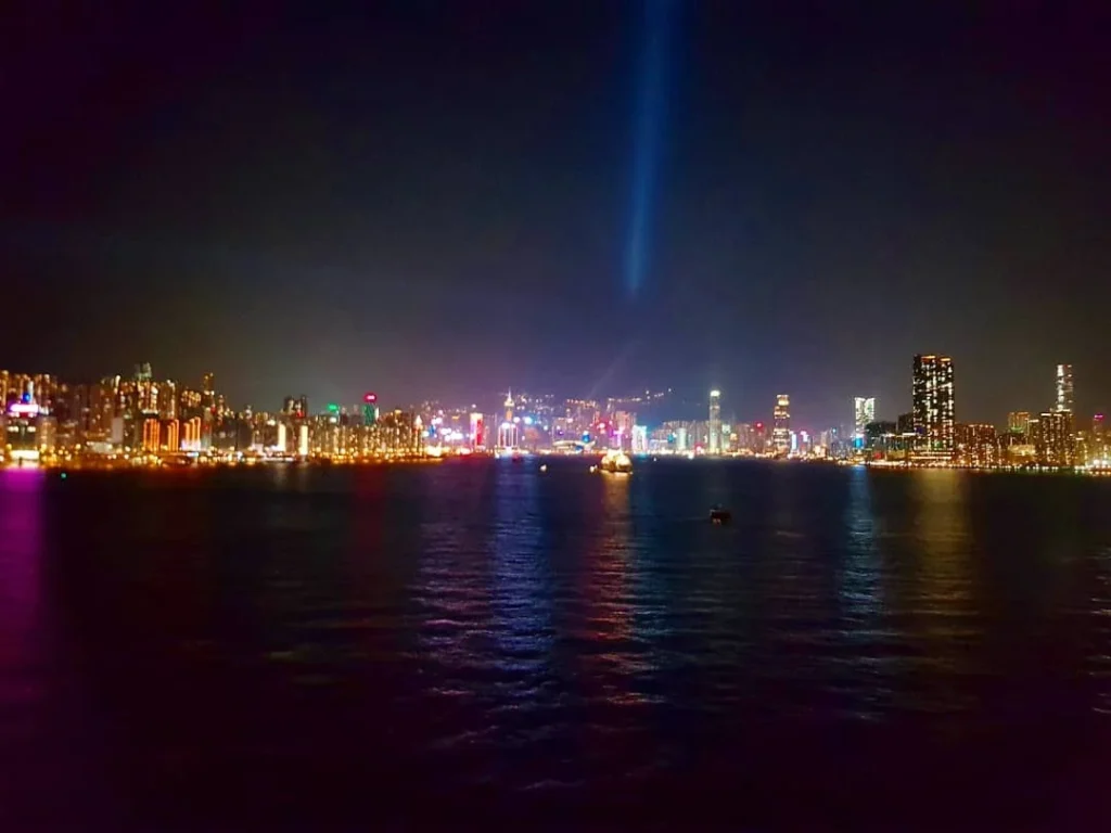 Cruising with Danny and Peter, Holland America Line, Westerdam, Hong Kong, China | A vibrant scene of Hong Kong's skyline during sunset, showcasing the majestic Westerdam cruise ship docked at the harbor, with tourists exploring the iconic Man Mo Temple, highlighting the cultural richness and luxury of a Hong Kong cruise experience.