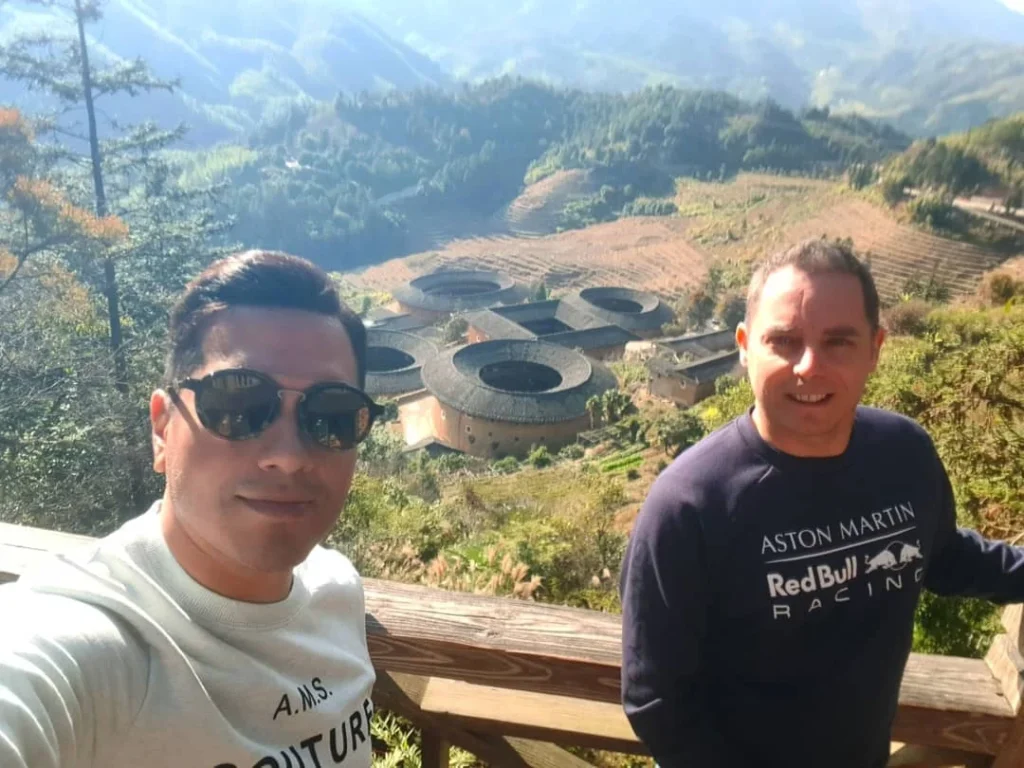 Xiamen Cruise Port: Our Complete Guide + Insider Tips 2026 (Visited Once in 2019 by Danny and Peter) 6 Cruising with Danny and Peter, Holland America Line, Westerdam, Xiamen, China | Exterior and interior views of Fujian Tulou, featuring traditional Hakka earthen architecture and intricate wooden carvings. Showcasing scenic Fujian Province landscapes and communal living structures at the UNESCO World Heritage site in Xiamen.