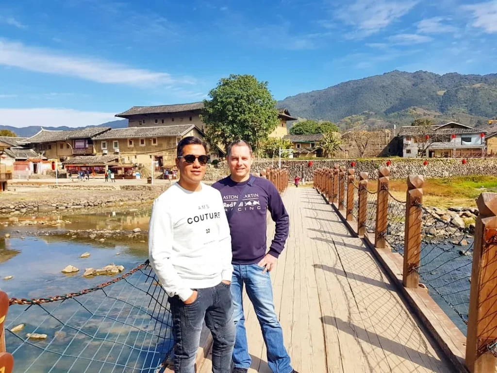 Xiamen Cruise Port: Our Complete Guide + Insider Tips 2026 (Visited Once in 2019 by Danny and Peter) 7 Cruising with Danny and Peter, Holland America Line, Westerdam, Xiamen, China | Exterior and interior views of Fujian Tulou, featuring traditional Hakka earthen architecture and intricate wooden carvings. Showcasing scenic Fujian Province landscapes and communal living structures at the UNESCO World Heritage site in Xiamen.