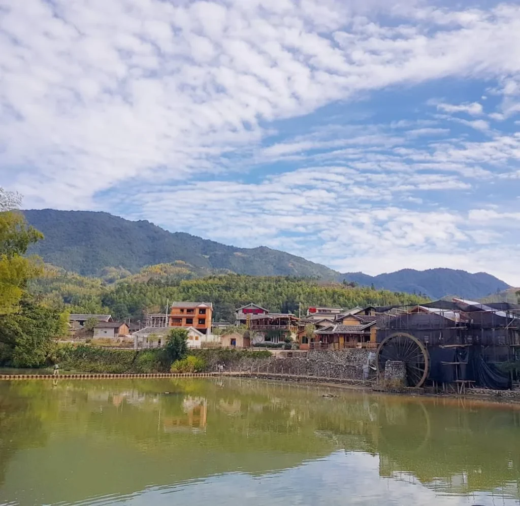 Xiamen Cruise Port: Our Complete Guide + Insider Tips 2026 (Visited Once in 2019 by Danny and Peter) 9 Cruising with Danny and Peter, Holland America Line, Westerdam, Xiamen, China | Exterior and interior views of Fujian Tulou, featuring traditional Hakka earthen architecture and intricate wooden carvings. Showcasing scenic Fujian Province landscapes and communal living structures at the UNESCO World Heritage site in Xiamen.