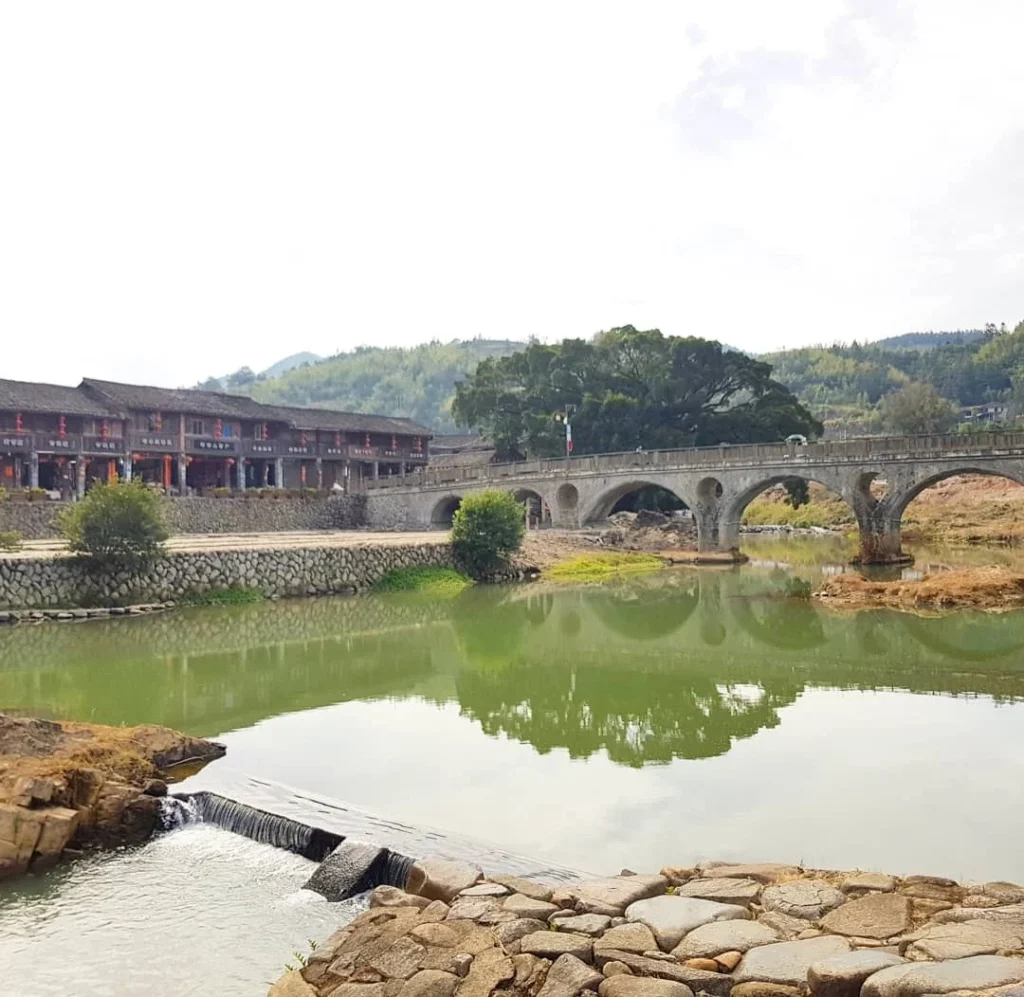 Xiamen Cruise Port: Our Complete Guide + Insider Tips 2026 (Visited Once in 2019 by Danny and Peter) 11 Cruising with Danny and Peter, Holland America Line, Westerdam, Xiamen, China | Exterior and interior views of Fujian Tulou, featuring traditional Hakka earthen architecture and intricate wooden carvings. Showcasing scenic Fujian Province landscapes and communal living structures at the UNESCO World Heritage site in Xiamen.