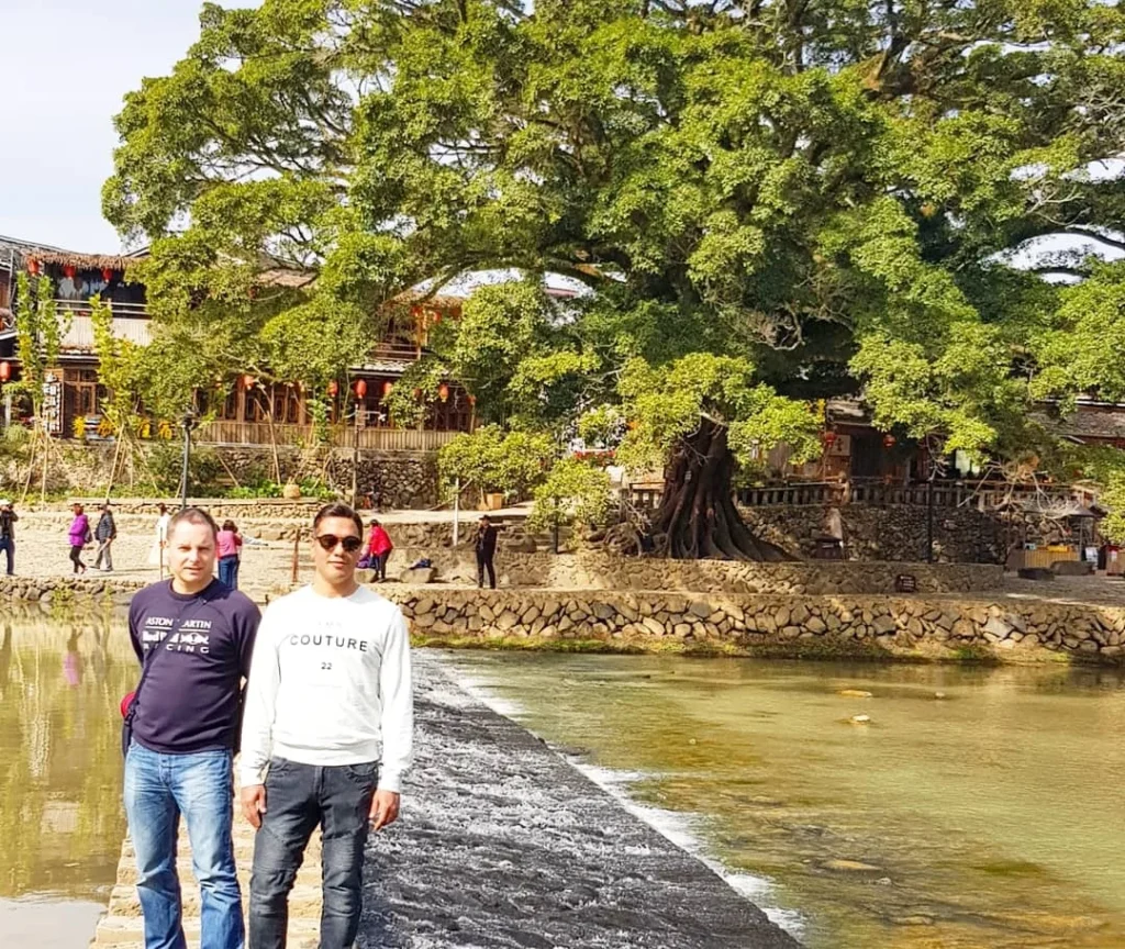 Xiamen Cruise Port: Our Complete Guide + Insider Tips 2026 (Visited Once in 2019 by Danny and Peter) 13 Cruising with Danny and Peter, Holland America Line, Westerdam, Xiamen, China | Exterior and interior views of Fujian Tulou, featuring traditional Hakka earthen architecture and intricate wooden carvings. Showcasing scenic Fujian Province landscapes and communal living structures at the UNESCO World Heritage site in Xiamen.