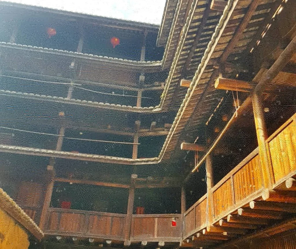 Xiamen Cruise Port: Our Complete Guide + Insider Tips 2026 (Visited Once in 2019 by Danny and Peter) 15 Cruising with Danny and Peter, Holland America Line, Westerdam, Xiamen, China | Exterior and interior views of Fujian Tulou, featuring traditional Hakka earthen architecture and intricate wooden carvings. Showcasing scenic Fujian Province landscapes and communal living structures at the UNESCO World Heritage site in Xiamen.
