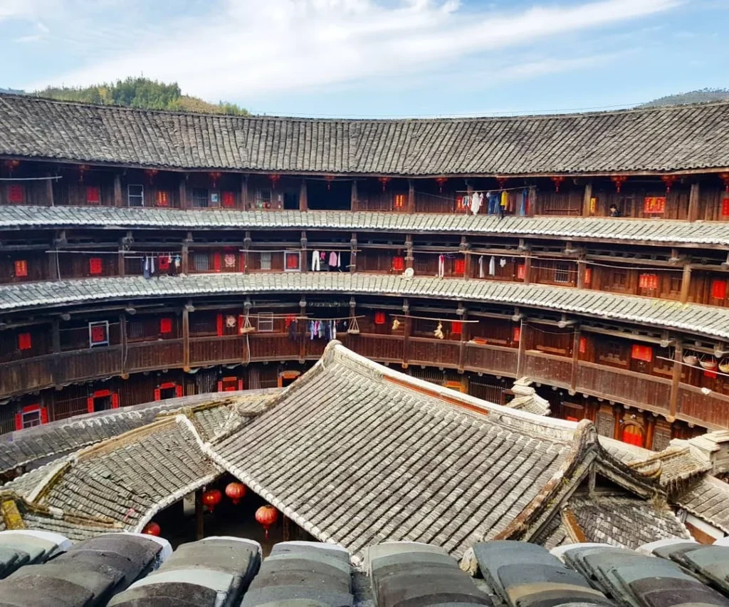 Xiamen Cruise Port: Our Complete Guide + Insider Tips 2026 (Visited Once in 2019 by Danny and Peter) 3 Cruising with Danny and Peter, Holland America Line, Westerdam, Xiamen, China | Exterior and interior views of Fujian Tulou, featuring traditional Hakka earthen architecture and intricate wooden carvings. Showcasing scenic Fujian Province landscapes and communal living structures at the UNESCO World Heritage site in Xiamen.