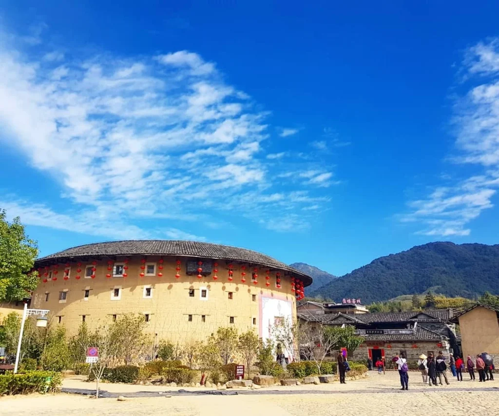 Xiamen Cruise Port: Our Complete Guide + Insider Tips 2026 (Visited Once in 2019 by Danny and Peter) 17 Cruising with Danny and Peter, Holland America Line, Westerdam, Xiamen, China | Exterior and interior views of Fujian Tulou, featuring traditional Hakka earthen architecture and intricate wooden carvings. Showcasing scenic Fujian Province landscapes and communal living structures at the UNESCO World Heritage site in Xiamen.