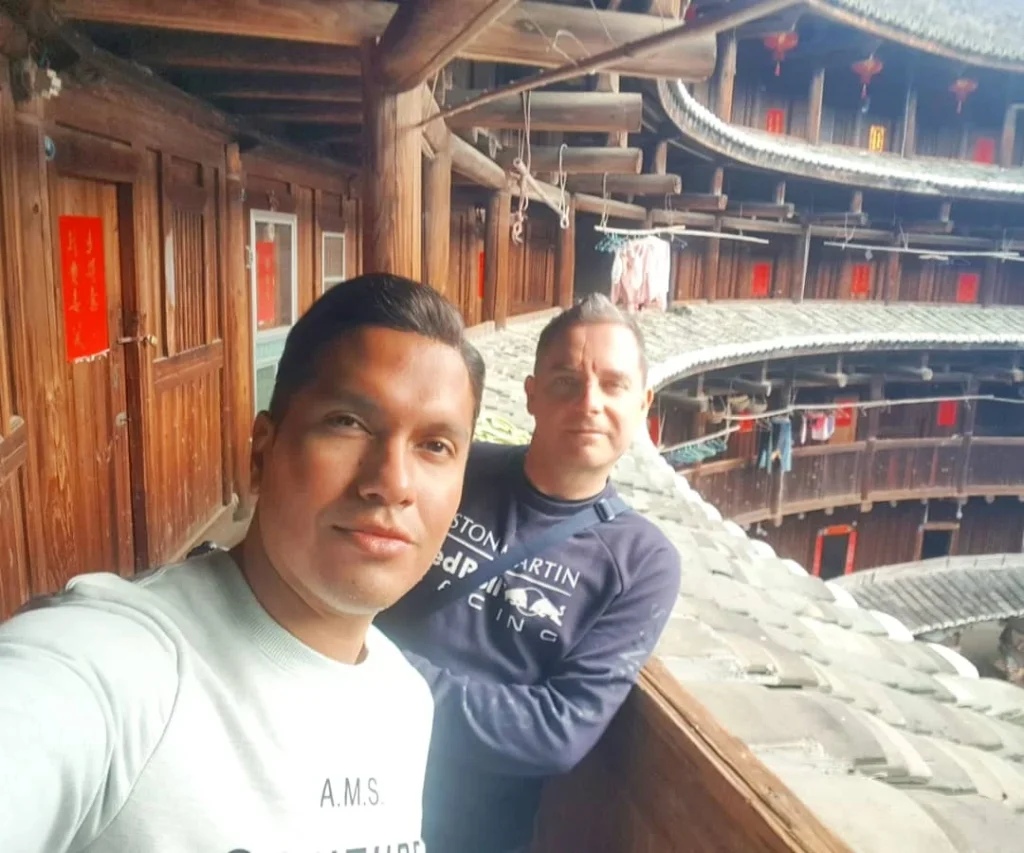 Xiamen Cruise Port: Our Complete Guide + Insider Tips 2026 (Visited Once in 2019 by Danny and Peter) 2 Cruising with Danny and Peter, Holland America Line, Westerdam, Xiamen, China | Exterior and interior views of Fujian Tulou, featuring traditional Hakka earthen architecture and intricate wooden carvings. Showcasing scenic Fujian Province landscapes and communal living structures at the UNESCO World Heritage site in Xiamen.