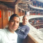 Cruising with Danny and Peter, Holland America Line, Westerdam, Xiamen, China | Exterior and interior views of Fujian Tulou, featuring traditional Hakka earthen architecture and intricate wooden carvings. Showcasing scenic Fujian Province landscapes and communal living structures at the UNESCO World Heritage site in Xiamen.