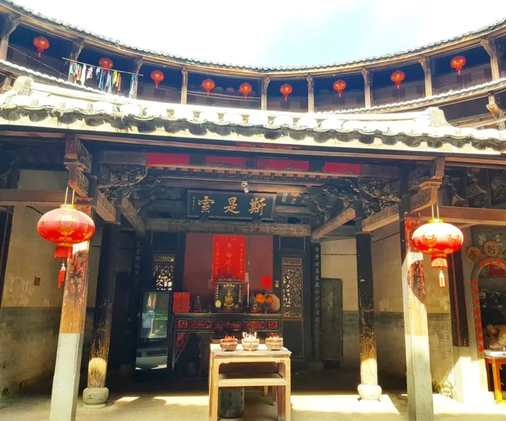 Xiamen Cruise Port: Our Complete Guide + Insider Tips 2026 (Visited Once in 2019 by Danny and Peter) 18 Cruising with Danny and Peter, Holland America Line, Westerdam, Xiamen, China | Exterior and interior views of Fujian Tulou, featuring traditional Hakka earthen architecture and intricate wooden carvings. Showcasing scenic Fujian Province landscapes and communal living structures at the UNESCO World Heritage site in Xiamen.