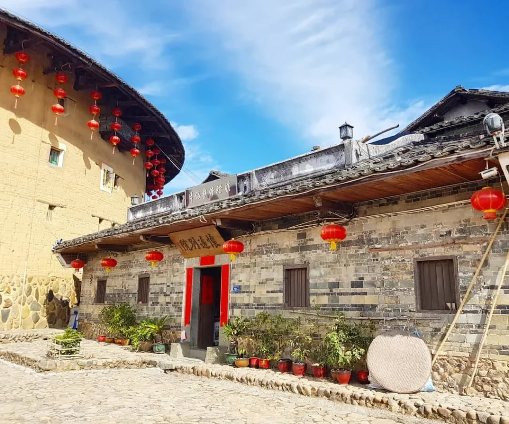 Xiamen Cruise Port: Our Complete Guide + Insider Tips 2026 (Visited Once in 2019 by Danny and Peter) 19 Cruising with Danny and Peter, Holland America Line, Westerdam, Xiamen, China | Exterior and interior views of Fujian Tulou, featuring traditional Hakka earthen architecture and intricate wooden carvings. Showcasing scenic Fujian Province landscapes and communal living structures at the UNESCO World Heritage site in Xiamen.